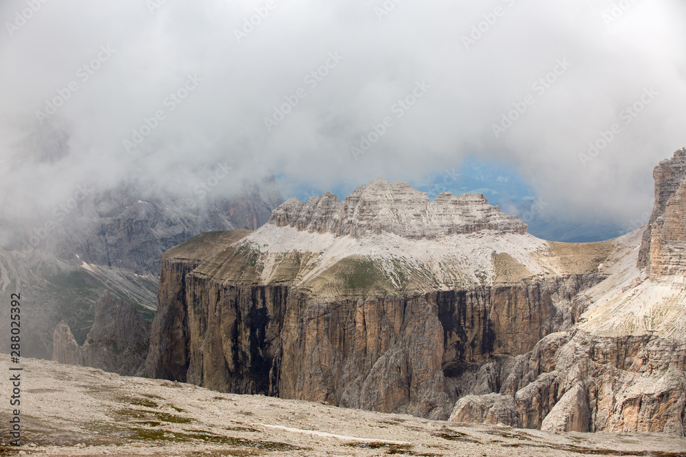 Piz Ciavazes on the Sella in the Dolomites with the Langkofel, Sassolungo in the Background. Clouds covering the Lang Kofel, Sasso Lungo. View from Piz Pordoi