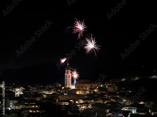 Fireworks above Kastelruth, Castelrotto in South Tyrol, during New Year Celebrations. Big Fireworks above Church steeple in Südtirol