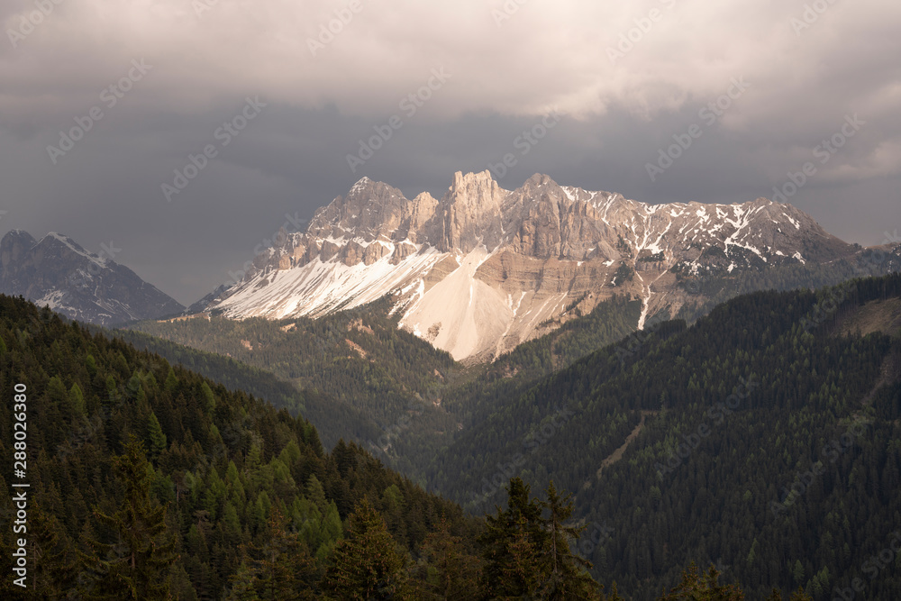 Aerial Landscape of the Dolomites, Sunset on a cloudy Day giving the Aferer Geisler Mountain a nice color.