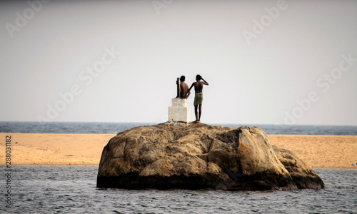 kids on top of elephant rock in poovar siland photo