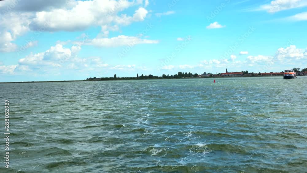 Tourist ship floating between village Volendam and island of Marken., Netherlands. 4K Tourist ship floating between village Volendam and island of Marken., Netherlands. 4K