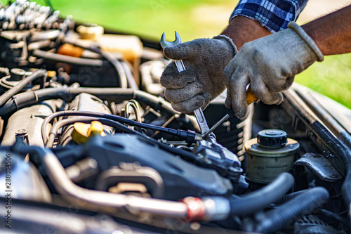 Auto mechanic repairing a car engine. Repair service