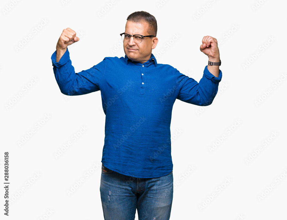 Middle age arab man wearing glasses over isolated background showing arms muscles smiling proud. Fitness concept. Middle age arab man wearing glasses over isolated background showing arms muscles smiling proud. Fitness concept.