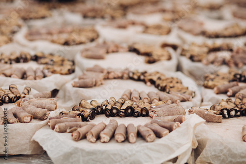 Close-up of many servings of meat and vegetarian rolls made of pork and aubergine served on platters over baking paper. Special event organization. Catering concept.