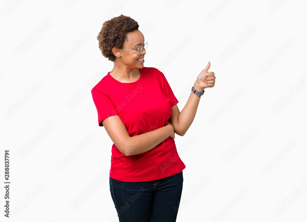 Beautiful young african american woman wearing glasses over isolated background Looking proud, smiling doing thumbs up gesture to the side Beautiful young african american woman wearing glasses over isolated background Looking proud, smiling doing thumbs up gesture to the side