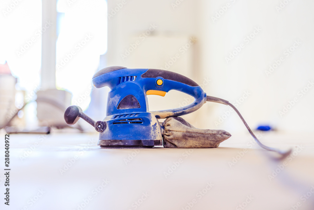 Renovating at home: sander tool for refreshing and grinding the wooden parquet floor