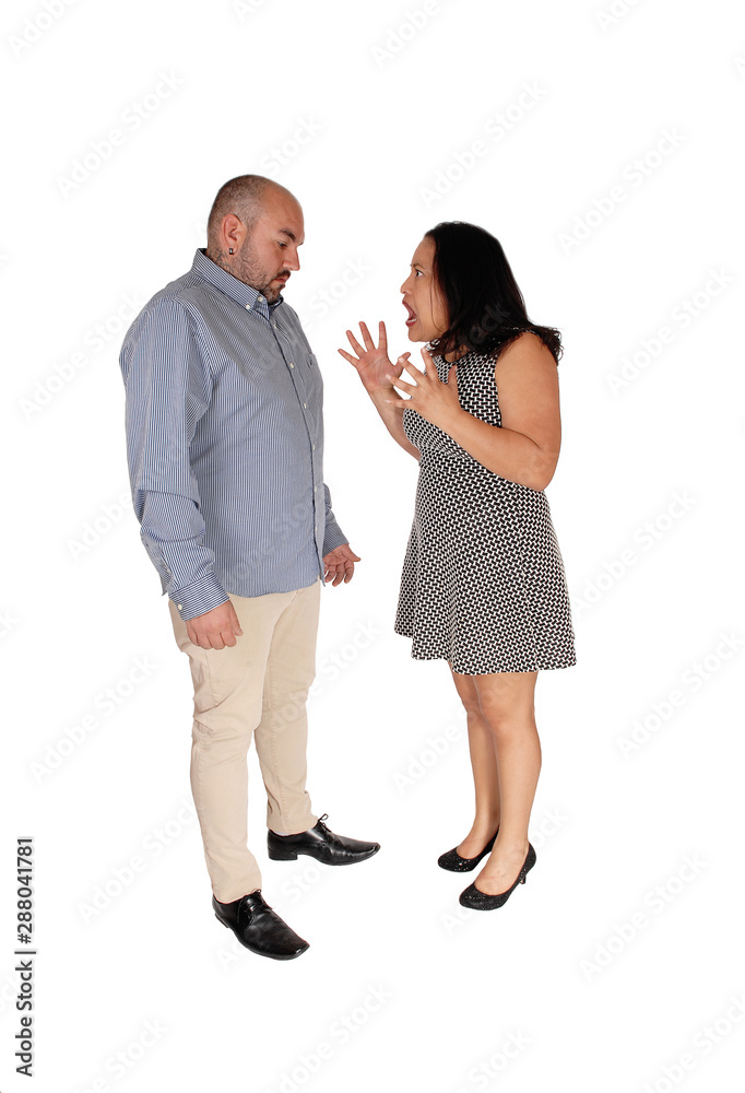 Fighting couple standing across each other in the studio Fighting couple standing across each other in the studio