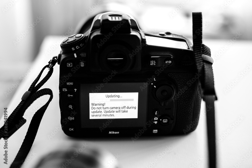 PARIS, FRANCE - JAN 31, 2018: Black and white Nikon DSLR Camera  Professional updating firmware with message on the screen: Do not turn  camera off during update Stock Photo | Adobe Stock