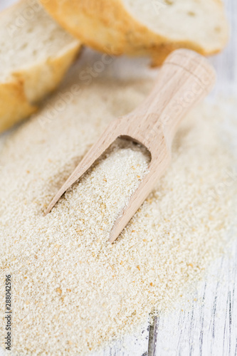 Vintage wooden table with Bread Crumbs (selective focus; close-up shot)