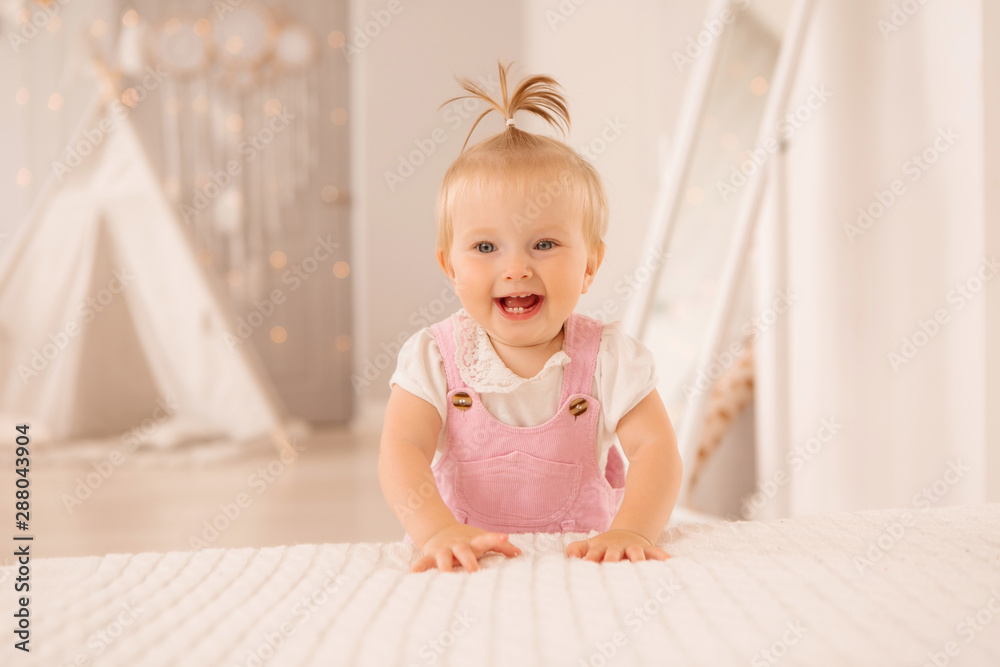 baby girl in the nursery playing,bright children's room, textiles for children's room baby girl in the nursery playing,bright children's room, textiles for children's room