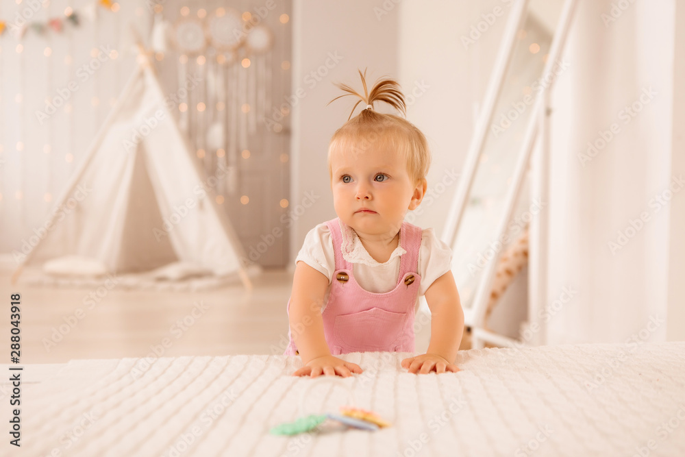 baby girl in the nursery playing,bright children's room, textiles for children's room baby girl in the nursery playing,bright children's room, textiles for children's room