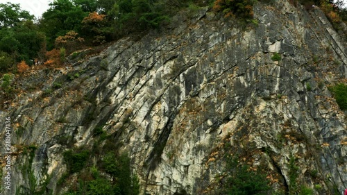 Belgium. Interesting folded sliced sedimentary rock formation in city. Beautiful town Durbuy. Popular tourist destination. 4K.