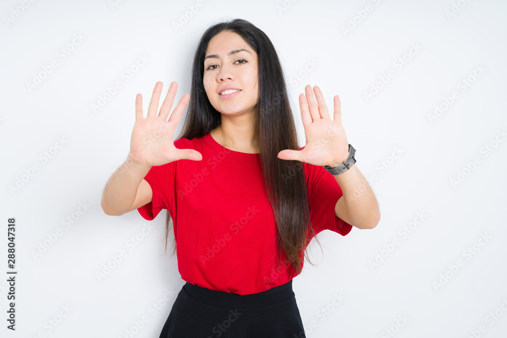 Beautiful brunette woman wearing red t-shirt over isolated background Smiling doing frame using hands palms and fingers, camera perspective Beautiful brunette woman wearing red t-shirt over isolated background Smiling doing frame using hands palms and fingers, camera perspective