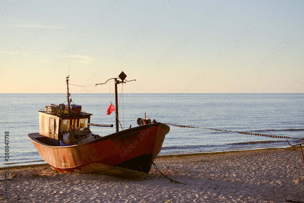 Fototapeta premium fisherman boats at sunrise time on the beach