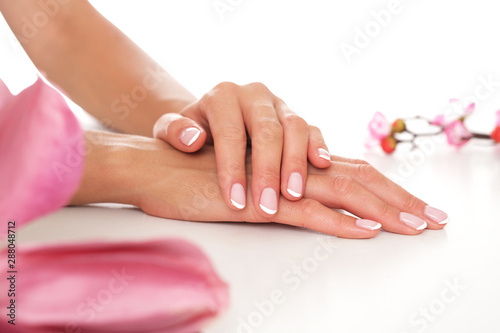 Smooth and well moisturized female hands on white background.