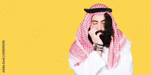 Cuadro en lienzo Arabian business man with long hair wearing traditional keffiyeh scarf thinking looking tired and bored with depression problems with crossed arms