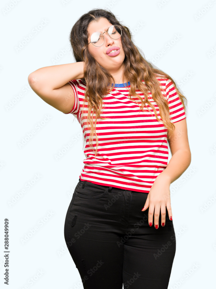Young beautiful woman wearing glasses Suffering of neck ache injury, touching neck with hand, muscular pain Young beautiful woman wearing glasses Suffering of neck ache injury, touching neck with hand, muscular pain
