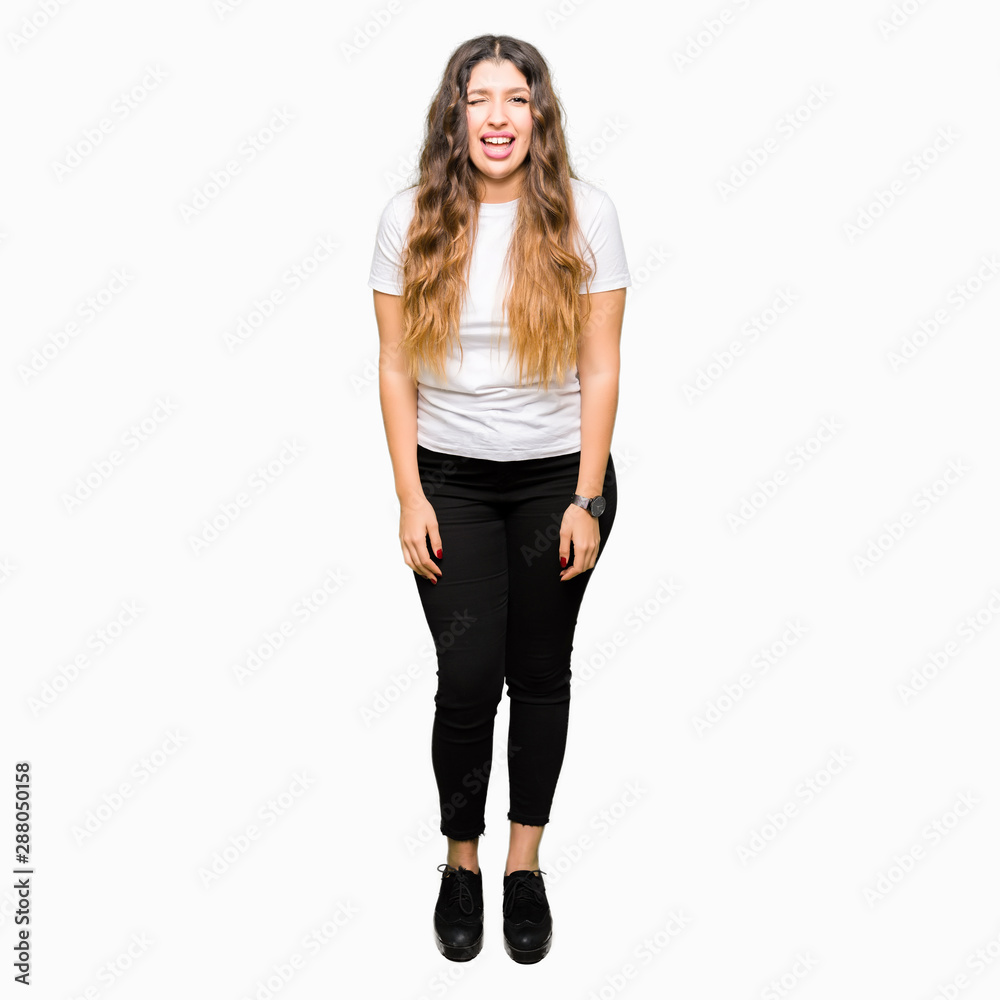 Young beautiful woman wearing casual white t-shirt winking looking at the camera with sexy expression, cheerful and happy face.