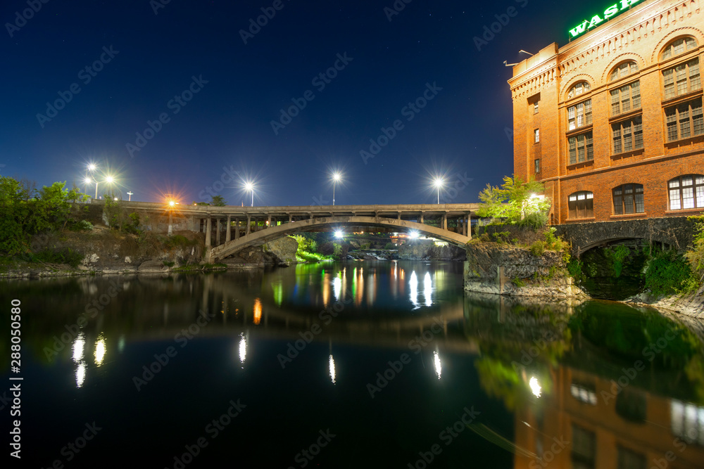 Evening in downtown Spokane Washington on the Spokane River near the historic utility building in Riverfront Park