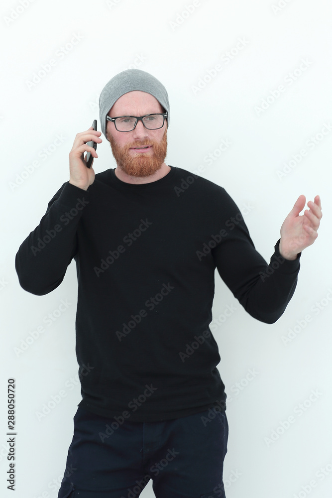 sporty young man talking on his smartphone . isolated on white sporty young man talking on his smartphone . isolated on white