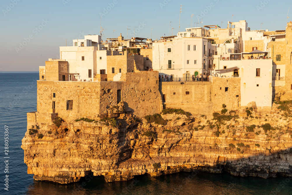 Italy, Apulia, Metropolitan City of Bari, Polignano a Mare. View of part of the old town, built on cliffs over the Adriatic Sea. Italy, Apulia, Metropolitan City of Bari, Polignano a Mare. View of part of the old town, built on cliffs over the Adriatic Sea.