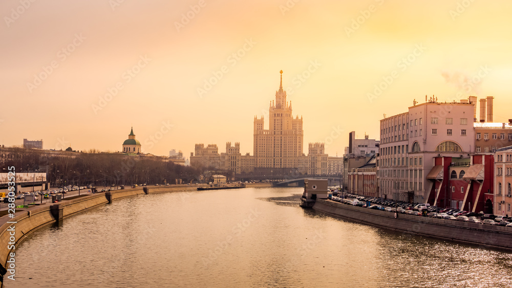 Panoramic cityscape with view at Kotelnicheskaya Embankment Building and Moskva River, during beautiful golden sunrise, Moscow, Russia