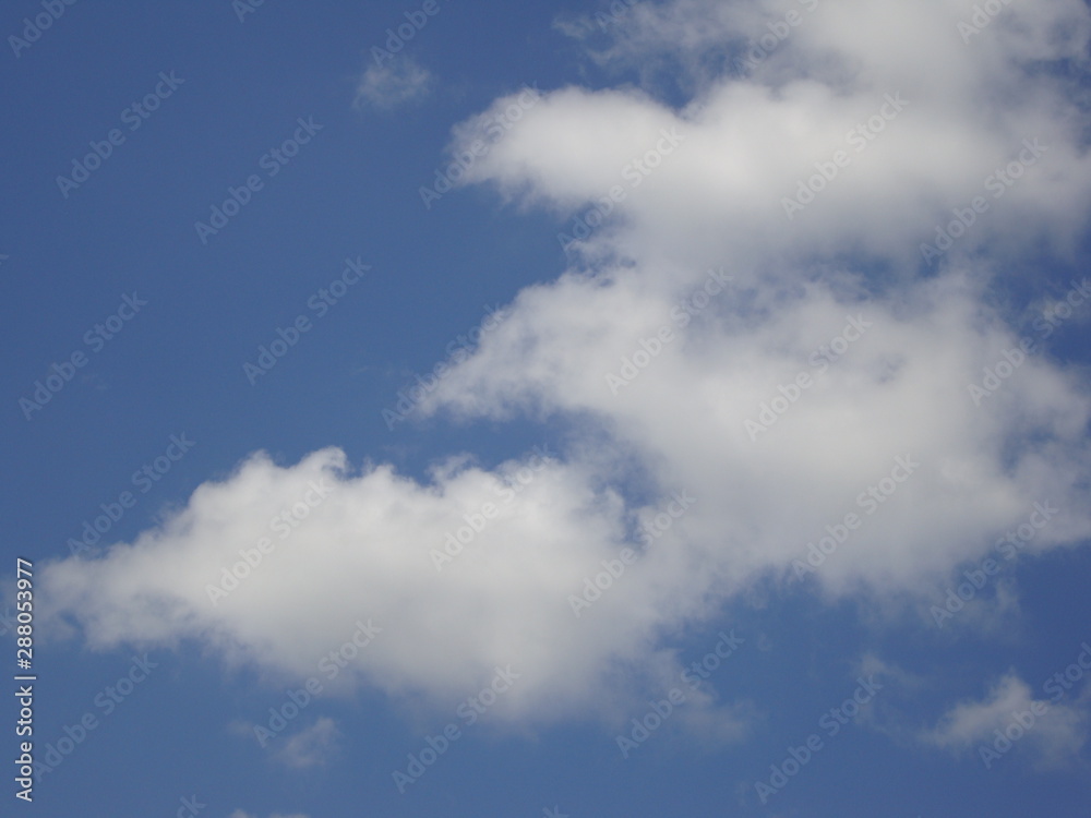 Fluffy White Clouds In Blue Sky Background