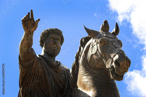 Bronze Roman equestrian statue of Emperor Marcus Aurelius, against the blue sky. Rome, Italy.. photo