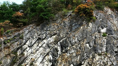 Belgium. Interesting folded sliced sedimentary rock formation in city. Beautiful town Durbuy. Popular tourist destination. 4K.