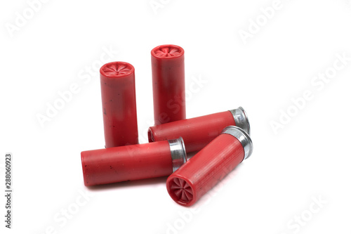 A close up image of a red shotgun shells, shot close up in macro, isolated on a clean, white background