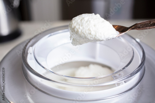 Vanilla ice cream being whiped in an ice cream machine photo