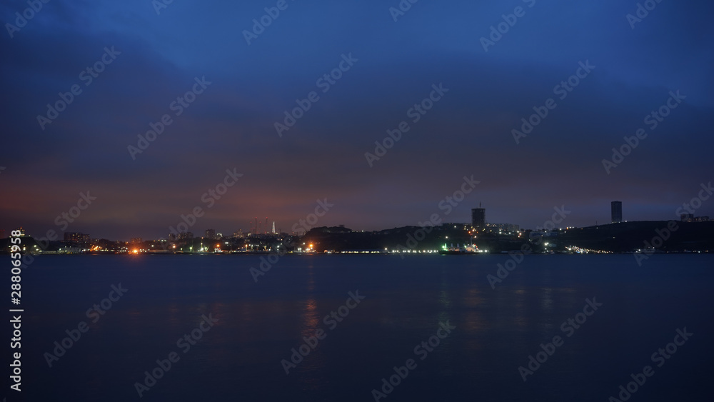 Seascape with coastline in blue hour.