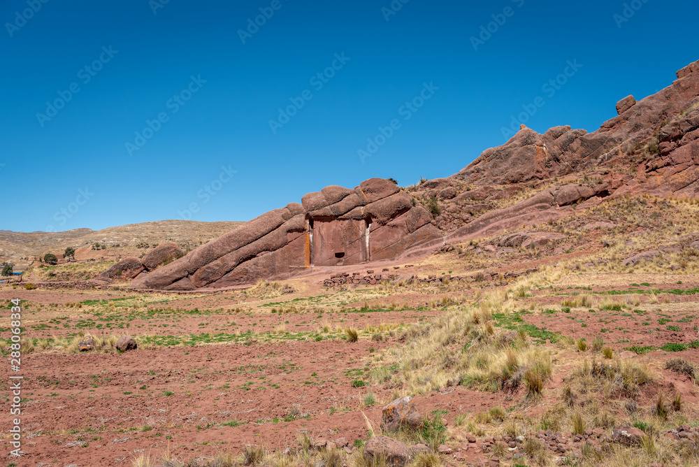 Gate of the Gods – a rock formation in shape of a man looking up into the sky with a cut out of a door on the side of his head. It is surrounded by a dry landscape on a clear and sunny day Gate of the Gods – a rock formation in shape of a man looking up into the sky with a cut out of a door on the side of his head. It is surrounded by a dry landscape on a clear and sunny day