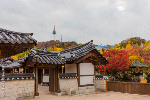 Autumn season of  Namsangol Hanok Village with seoul tower  in Seoul South Korea.. photo