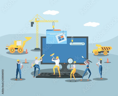 builders and desktop with webpage under cosntruction