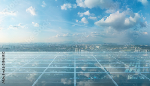 Empty transparent glass floor on rooftop with city skyline