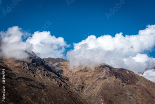 Low clouds hovering around the dry, rocky mountain tops in the Sacred Valley near Ollantaytambo