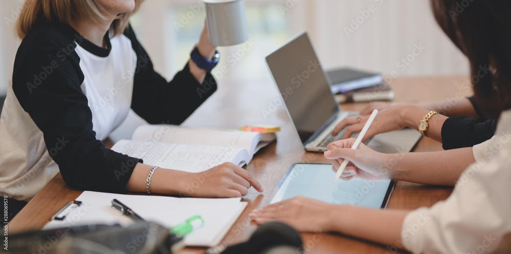 Close-up view of young professional business team discussing the plan about the upcoming project together