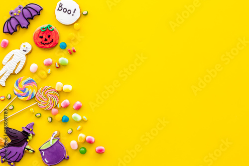 Creepy cookies for halloween treat frame on yellow background top view mockup