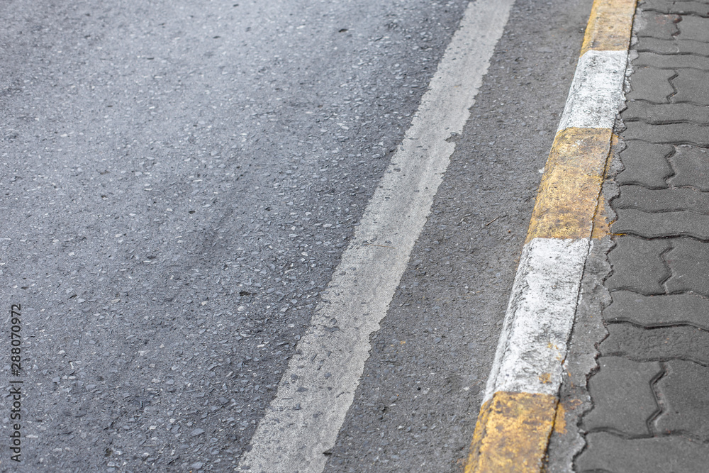 Yellow and white lines on footpath