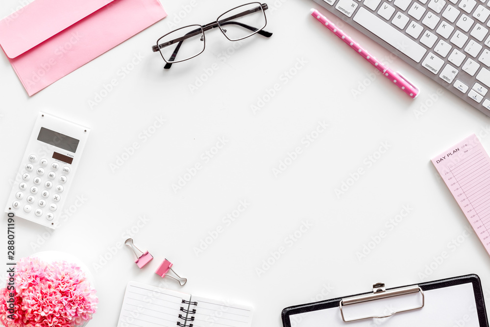 Female work desk with pink supplies on white background flat lay copy space top view Female work desk with pink supplies on white background flat lay copy space top view