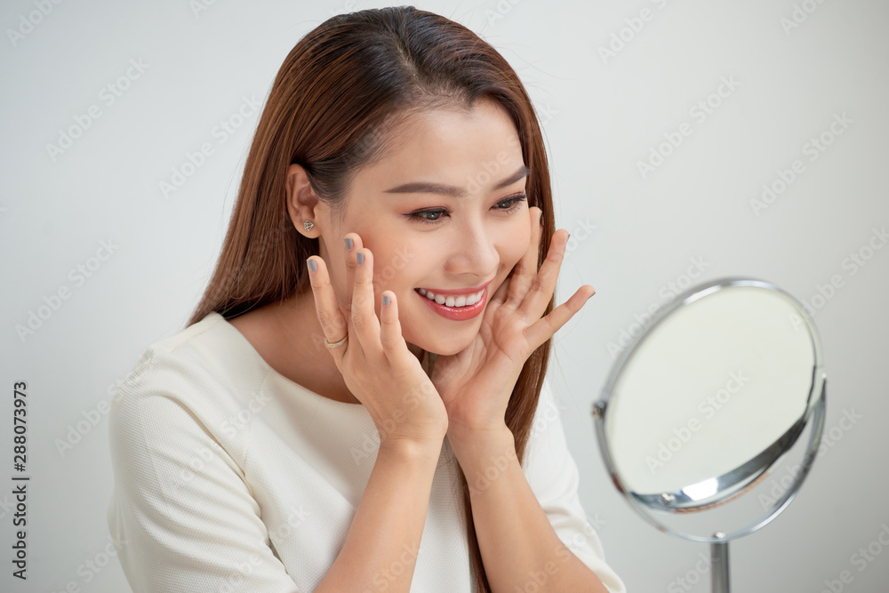 face of young beautiful healthy woman looking in the mirror face of young beautiful healthy woman looking in the mirror