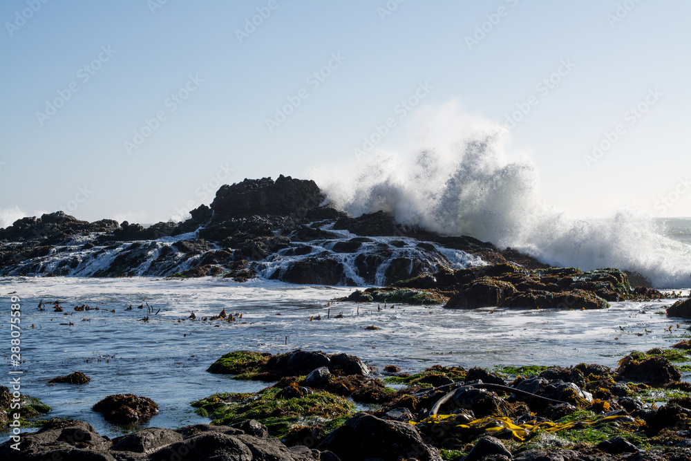 huge waves crashing over Rocky California coast.