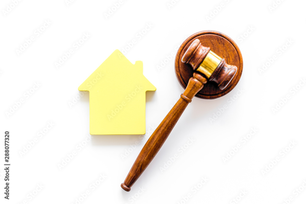 Inheritance of the house concept with figure and gavel on white background top view Inheritance of the house concept with figure and gavel on white background top view