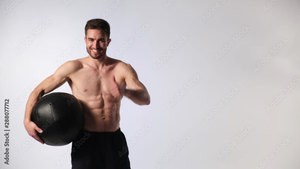 bearded handsome sportsman with a medball in his hands on a white background bearded handsome sportsman with a medball in his hands on a white background