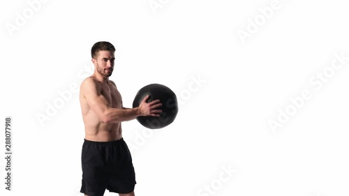 bearded handsome sportsman with a medball in his hands on a white background photo