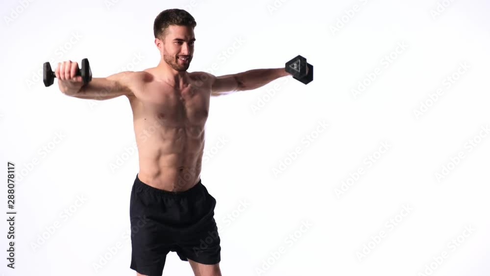 young handsome man with a beard naked torso on a white background is engaged in sports fitness activity lifting dumbbells. exercises with dumbbells on bissepsi and shoulders young handsome man with a beard naked torso on a white background is engaged in sports fitness activity lifting dumbbells. exercises with dumbbells on bissepsi and shoulders