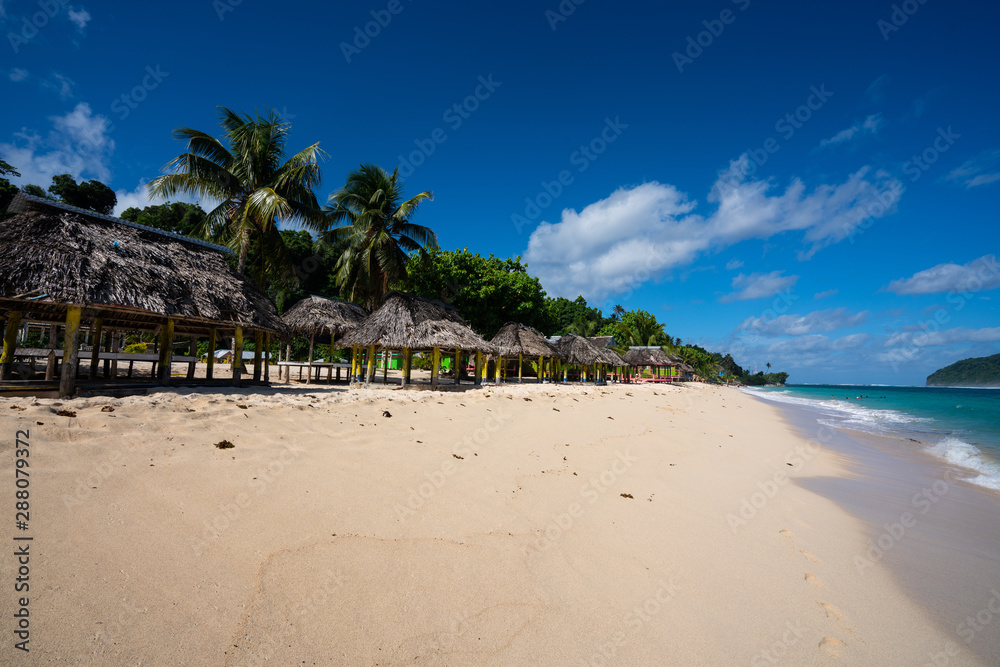 Beach fale's on a white sand beach on Lalomanu, Samoa Beach fale's on a white sand beach on Lalomanu, Samoa