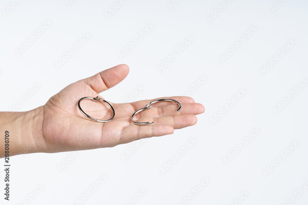 Hand holding steel split ring loop for book Hand holding steel split ring loop for book