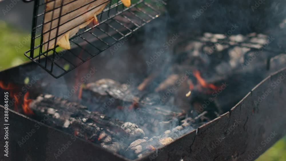 man on grill, roasting a large pita bread, on small fire man on grill, roasting a large pita bread, on small fire